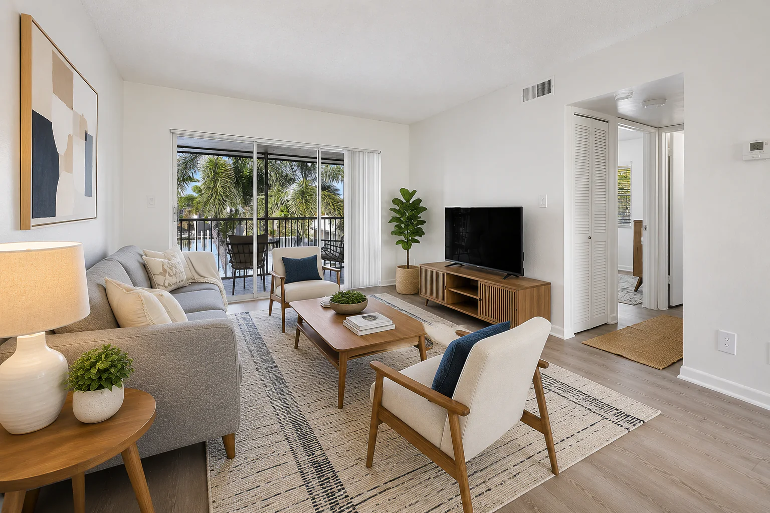 Orderly Boca STR living room with screened balcony access