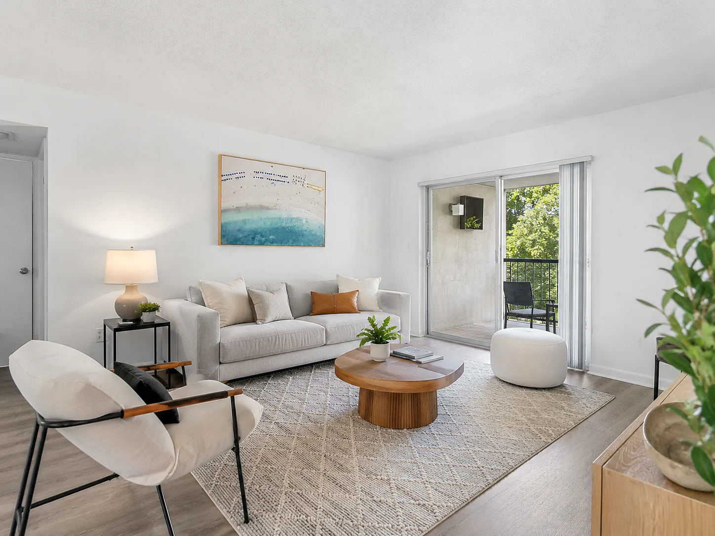 Bright furnished living room opening onto the balcony